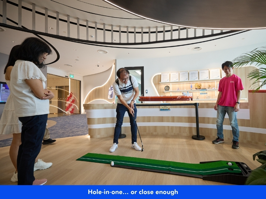 Colleague playing mini golf