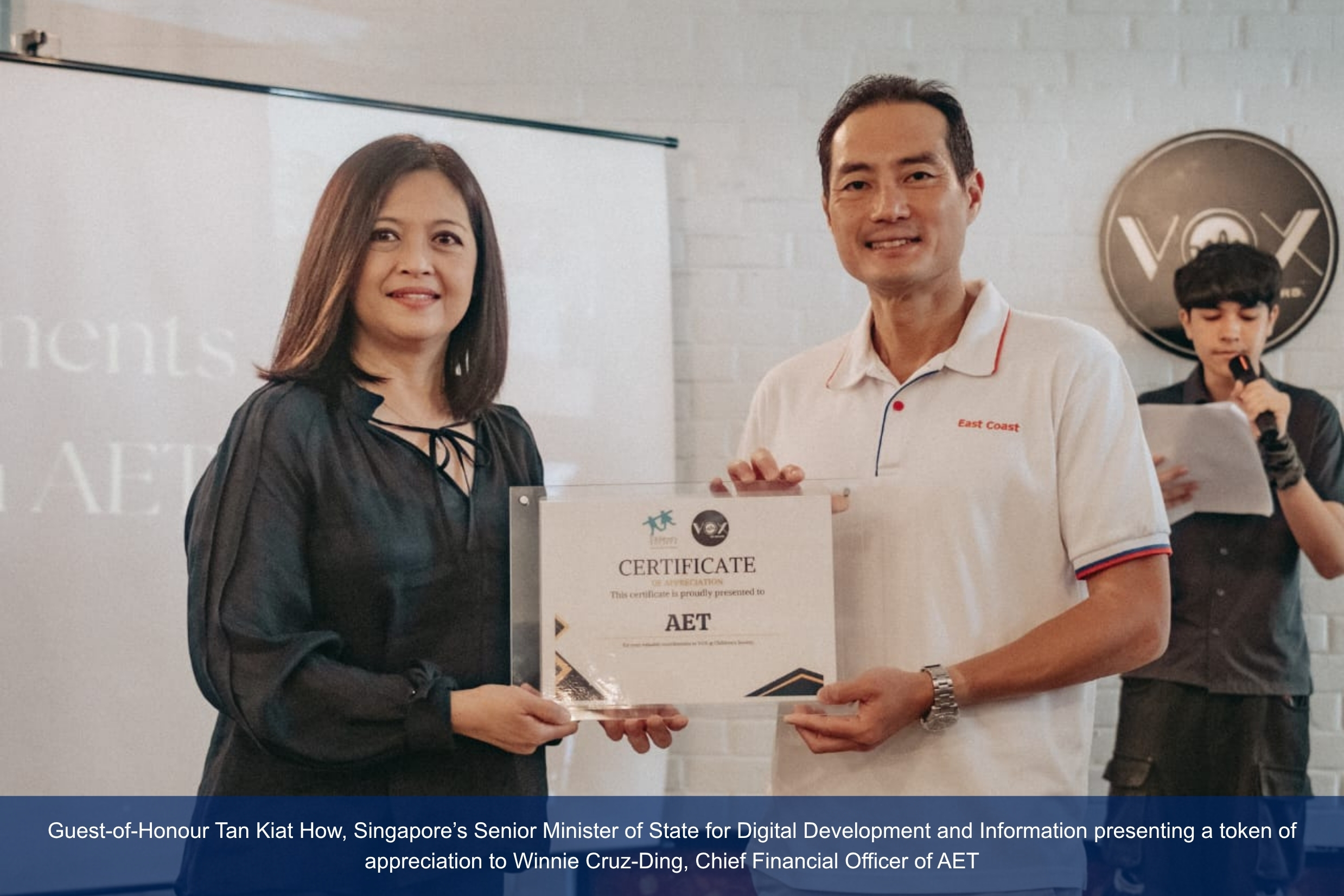 Winnie receiving certificate from Minister Tan Kiat How