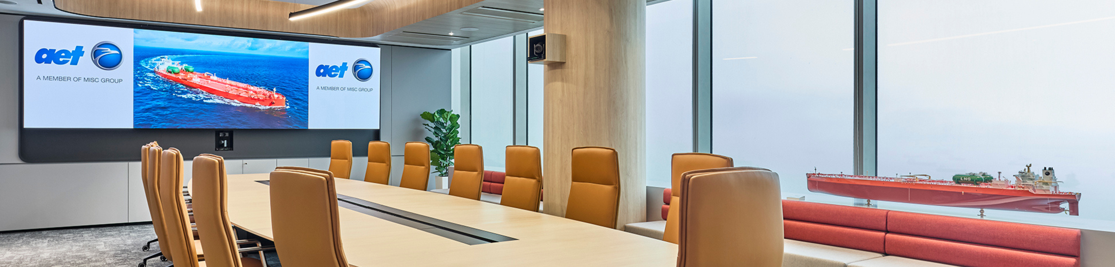 Close-up of a person's hands holding a compass and measuring on a nautical map