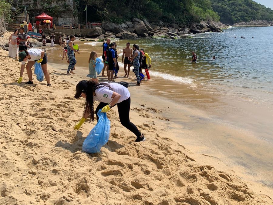AET staff cleaning the beach